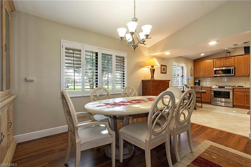 194 Albi Road, Unit 8 Naples, FL 34112 - Photo 4 of 12 a view of a dining room with furniture window and wooden floor