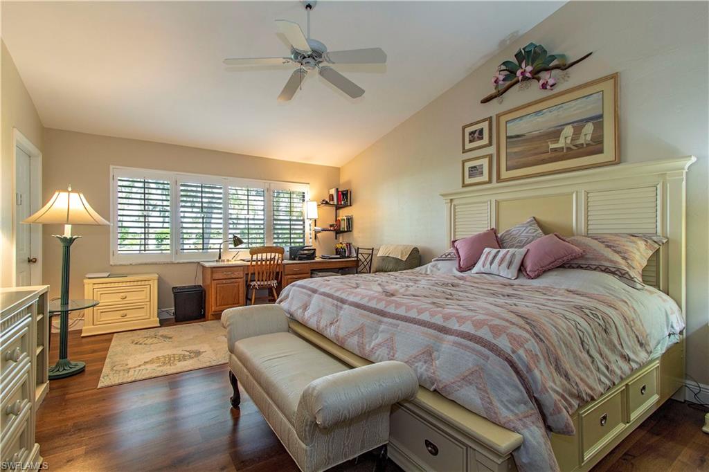 194 Albi Road, Unit 8 Naples, FL 34112 - Photo 7 of 12 a bedroom with a balcony a bed and a view of kitchen