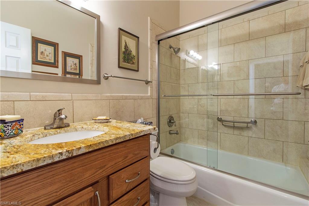194 Albi Road, Unit 8 Naples, FL 34112 - Photo 10 of 12 a bathroom with a sink a toilet and shower