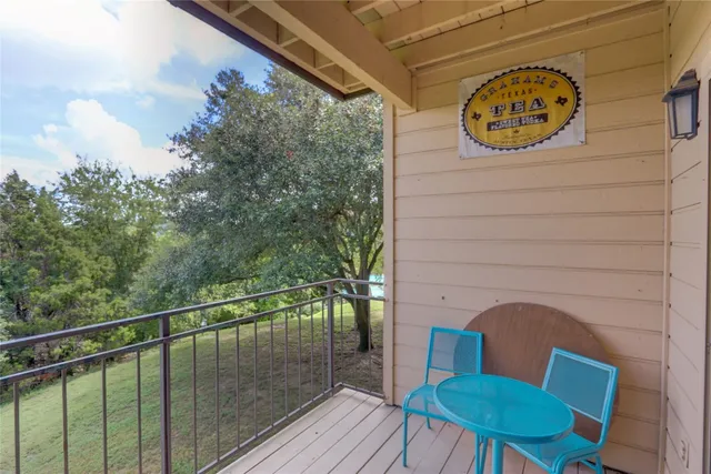 a view of a balcony with wooden fence