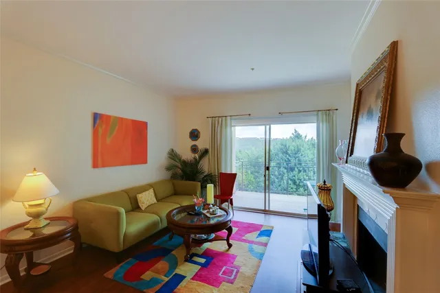 a living room with furniture and a floor to ceiling window