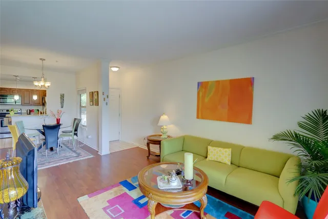 a living room with furniture and a dining table