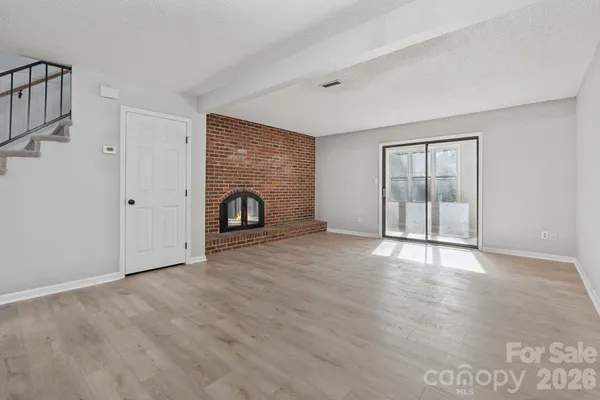 wooden floor fireplace and natural light in room