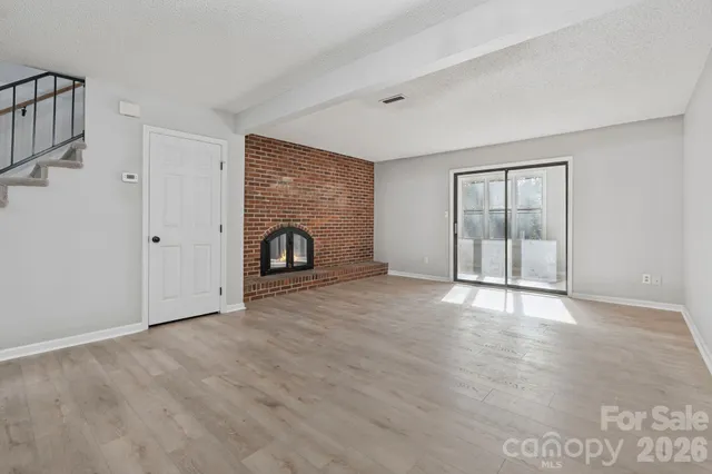 wooden floor fireplace and natural light in room