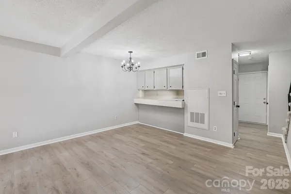 a view of kitchen and empty room
