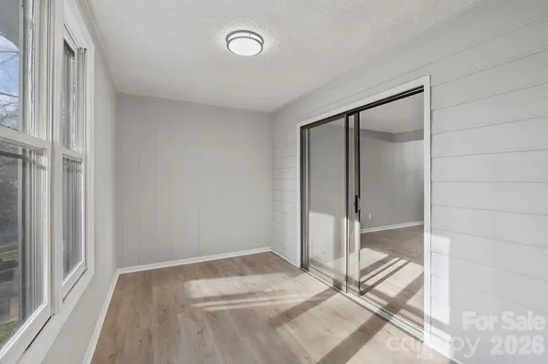 a view of a room with wooden floor and a bathroom