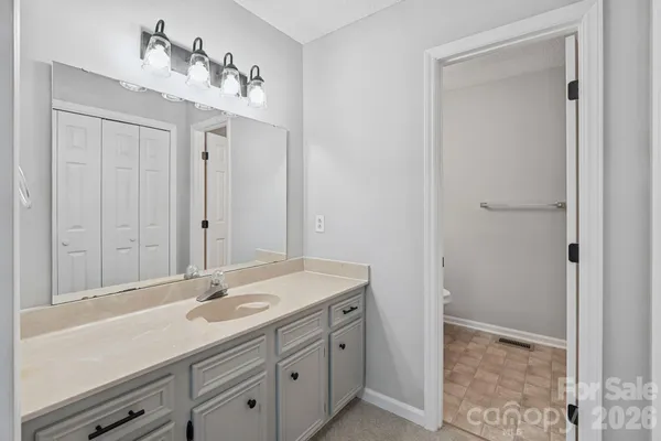 a bathroom with a sink a vanity and a mirror