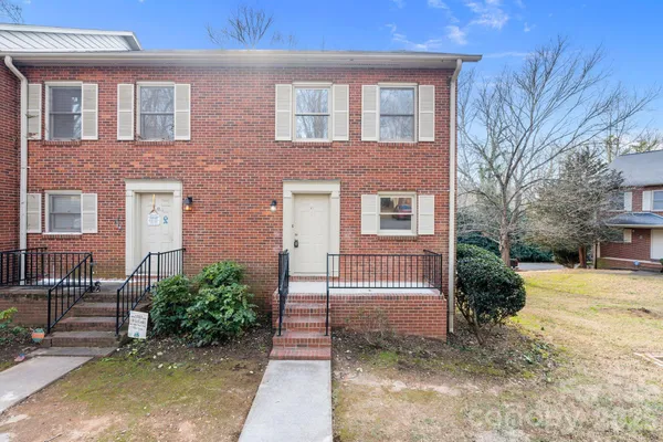 a view of a brick house with a yard