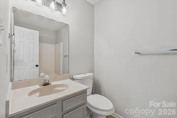 a bathroom with a sink a toilet and vanity