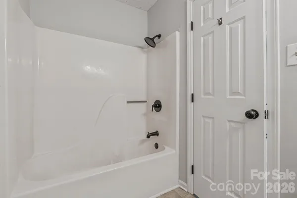 a bathroom with a tub shower