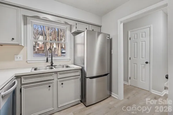 a kitchen with appliances cabinets and a sink