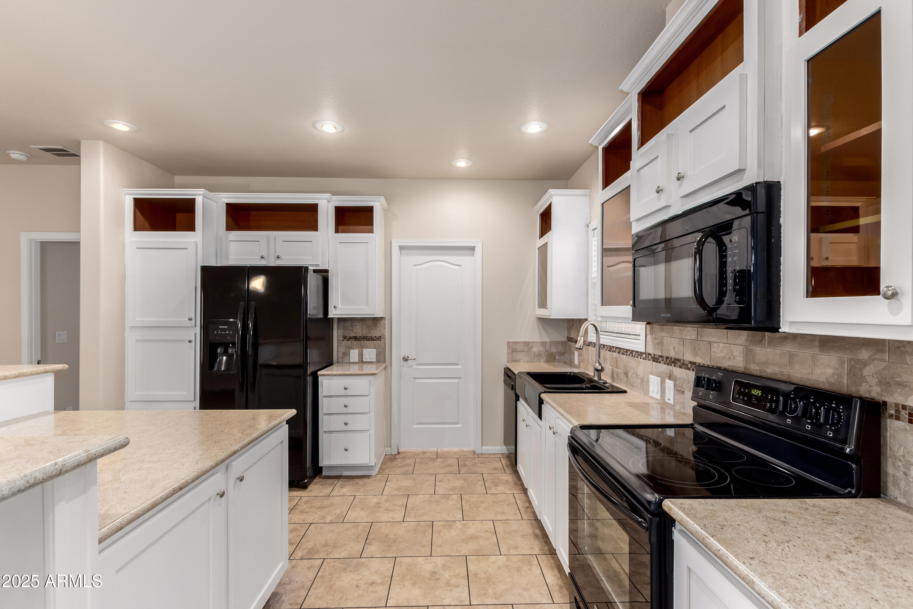2000 South Apache Road, Unit 78 Buckeye, AZ 85326 - Photo 3 of 8 a kitchen with stainless steel appliances granite countertop a stove and a refrigerator