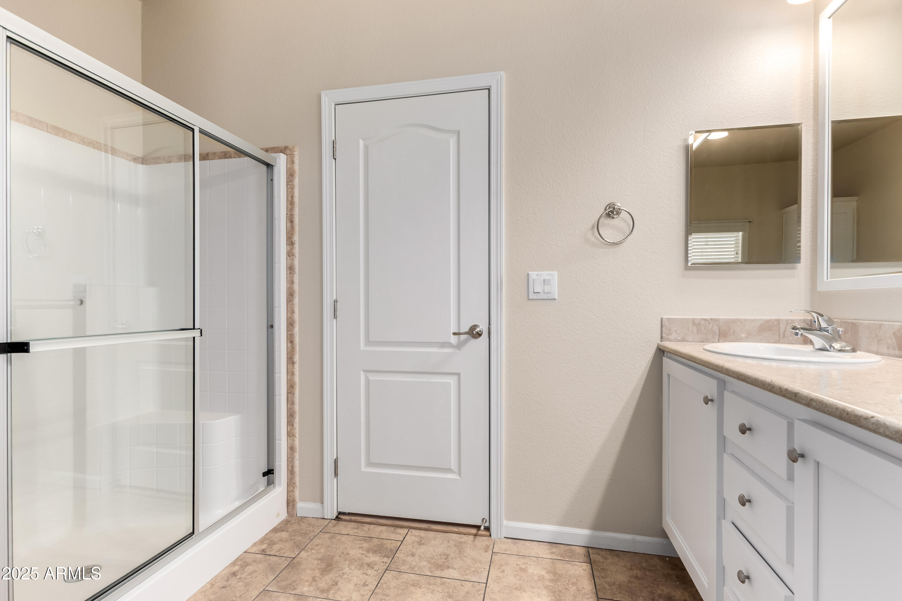 2000 South Apache Road, Unit 78 Buckeye, AZ 85326 - Photo 5 of 8 a bathroom with a granite countertop sink mirror and shower