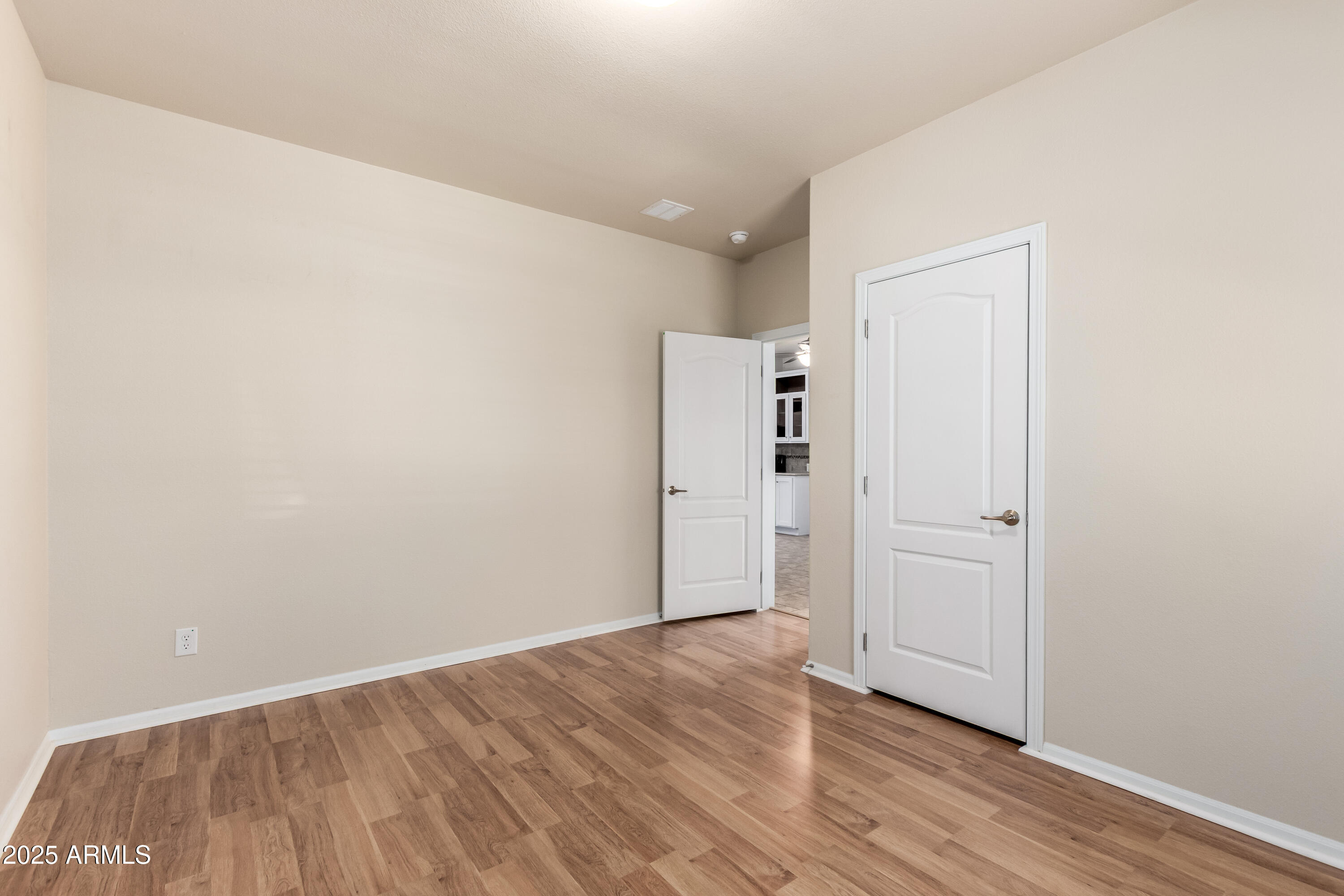 2000 South Apache Road, Unit 78 Buckeye, AZ 85326 - Photo 7 of 8 a view of an empty room with wooden floor