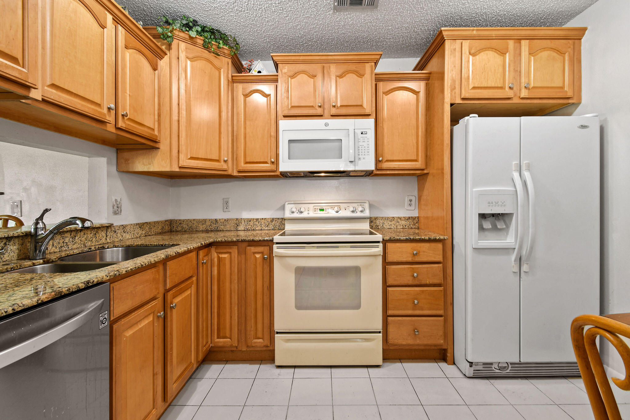 160 Banyan Circle Jupiter, FL 33458 - Photo 21 of 62 a kitchen with stainless steel appliances granite countertop a refrigerator sink and stove