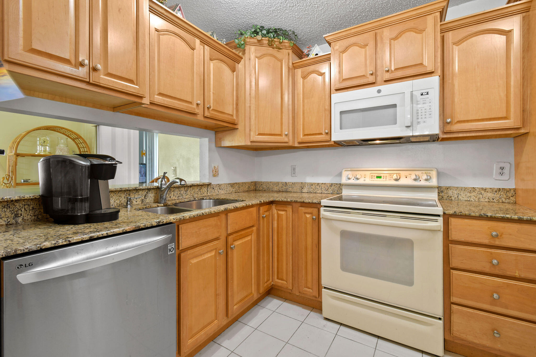 160 Banyan Circle Jupiter, FL 33458 - Photo 22 of 62 a kitchen with stainless steel appliances granite countertop a sink dishwasher a stove and cabinets with wooden floor