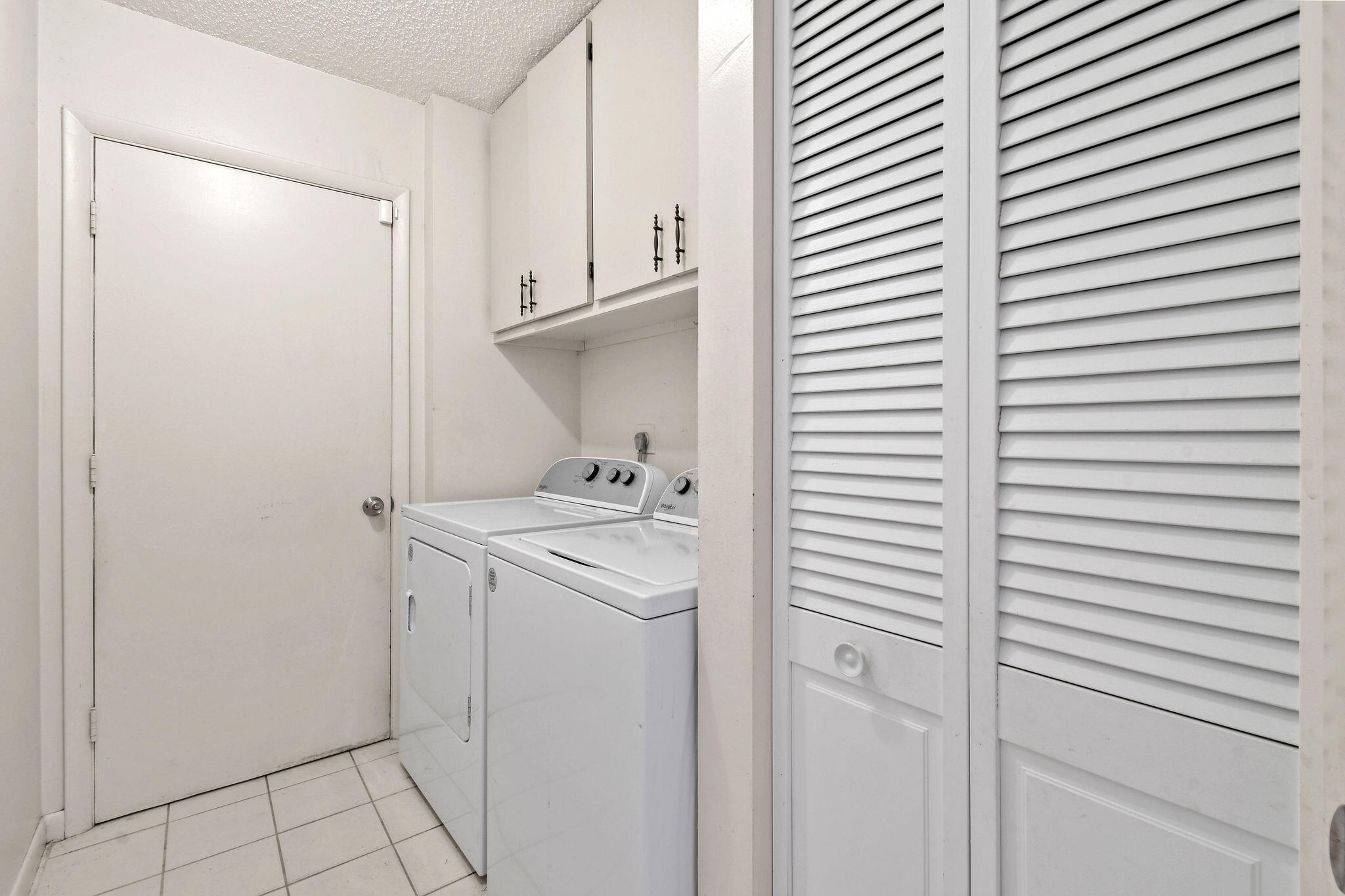 160 Banyan Circle Jupiter, FL 33458 - Photo 43 of 62 a utility room with cabinets washer and dryer