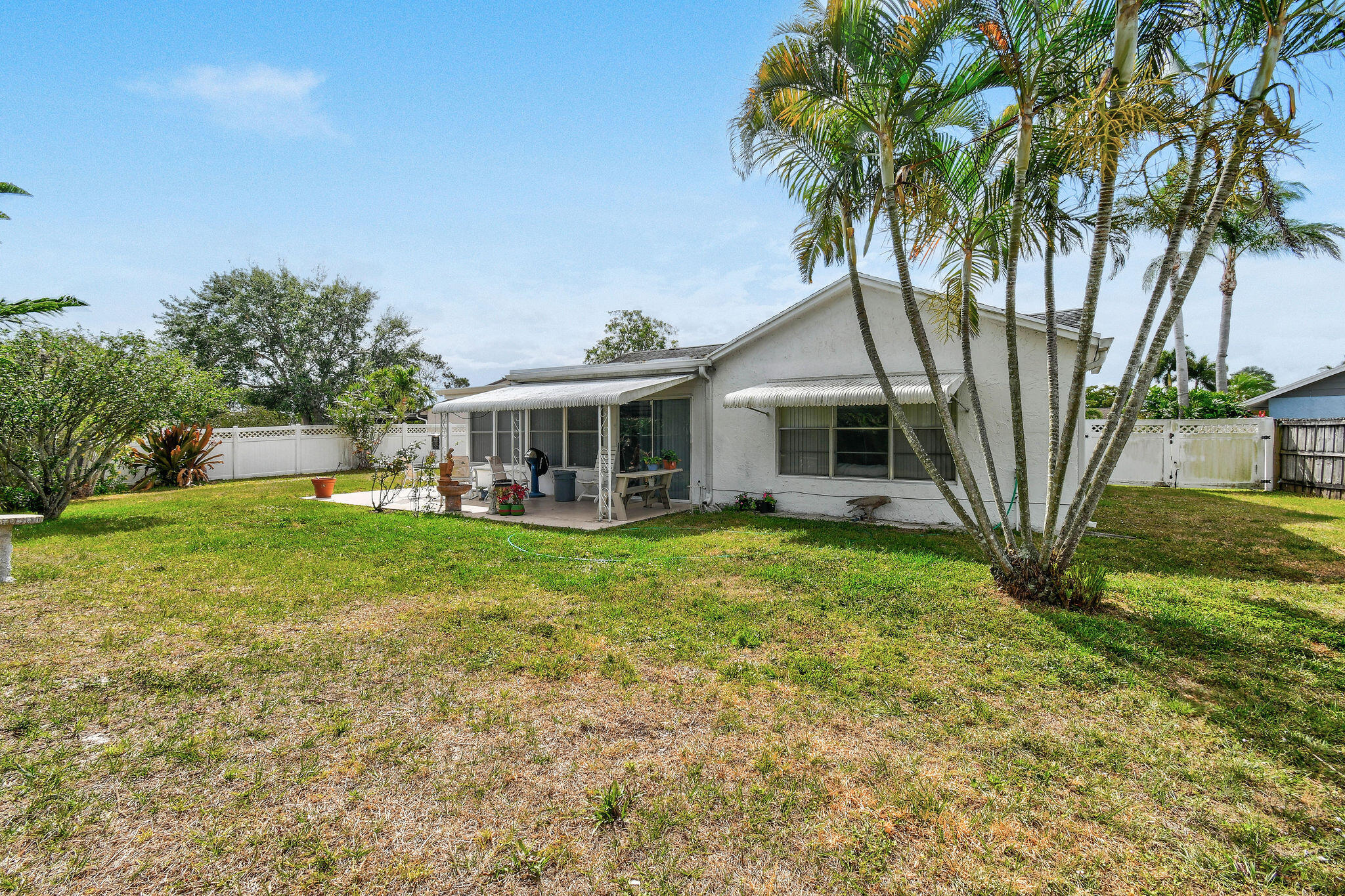 160 Banyan Circle Jupiter, FL 33458 - Photo 57 of 62 a front view of a house with yard and green space