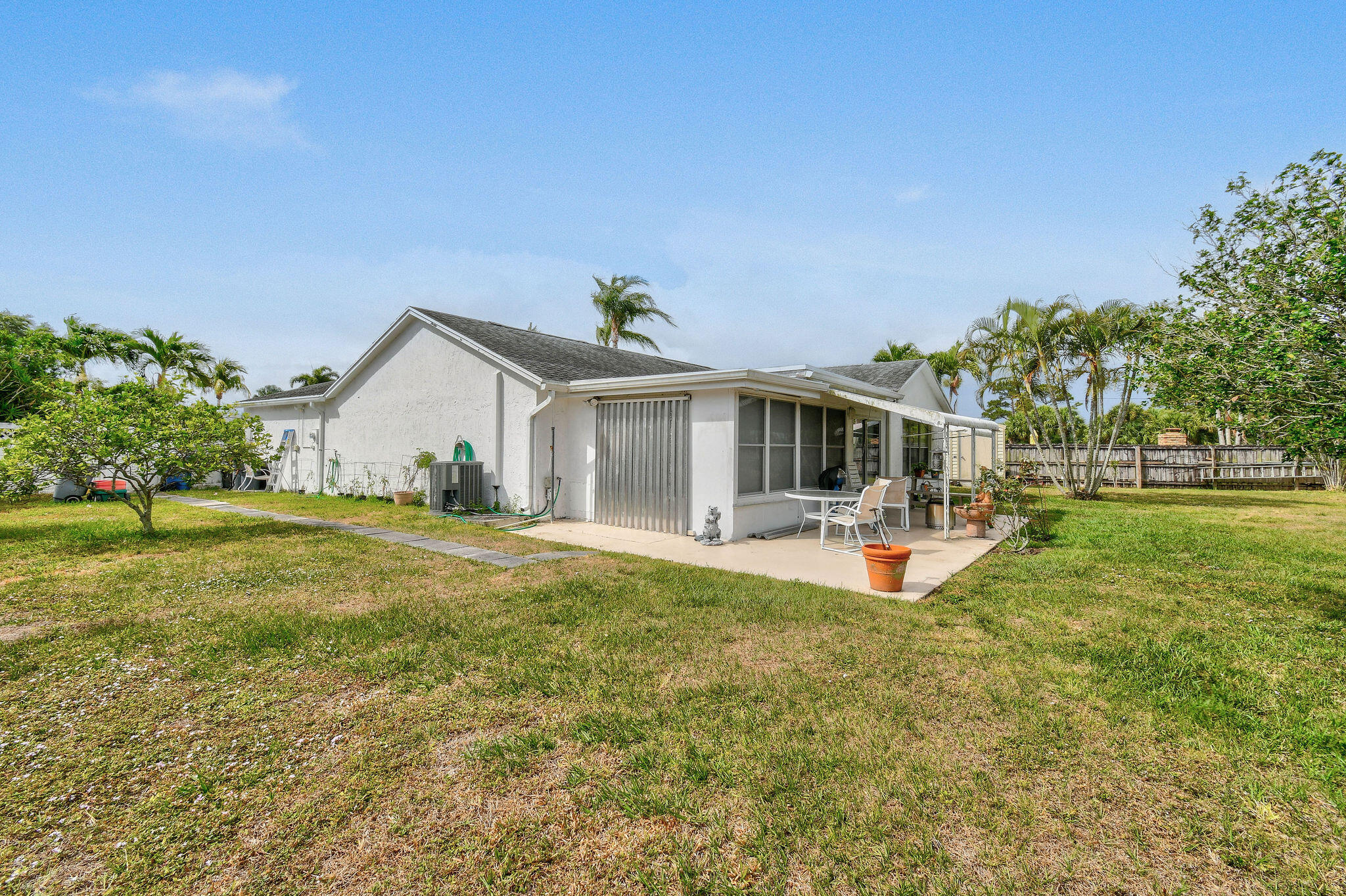 160 Banyan Circle Jupiter, FL 33458 - Photo 59 of 62 a front view of a house with patio and garden