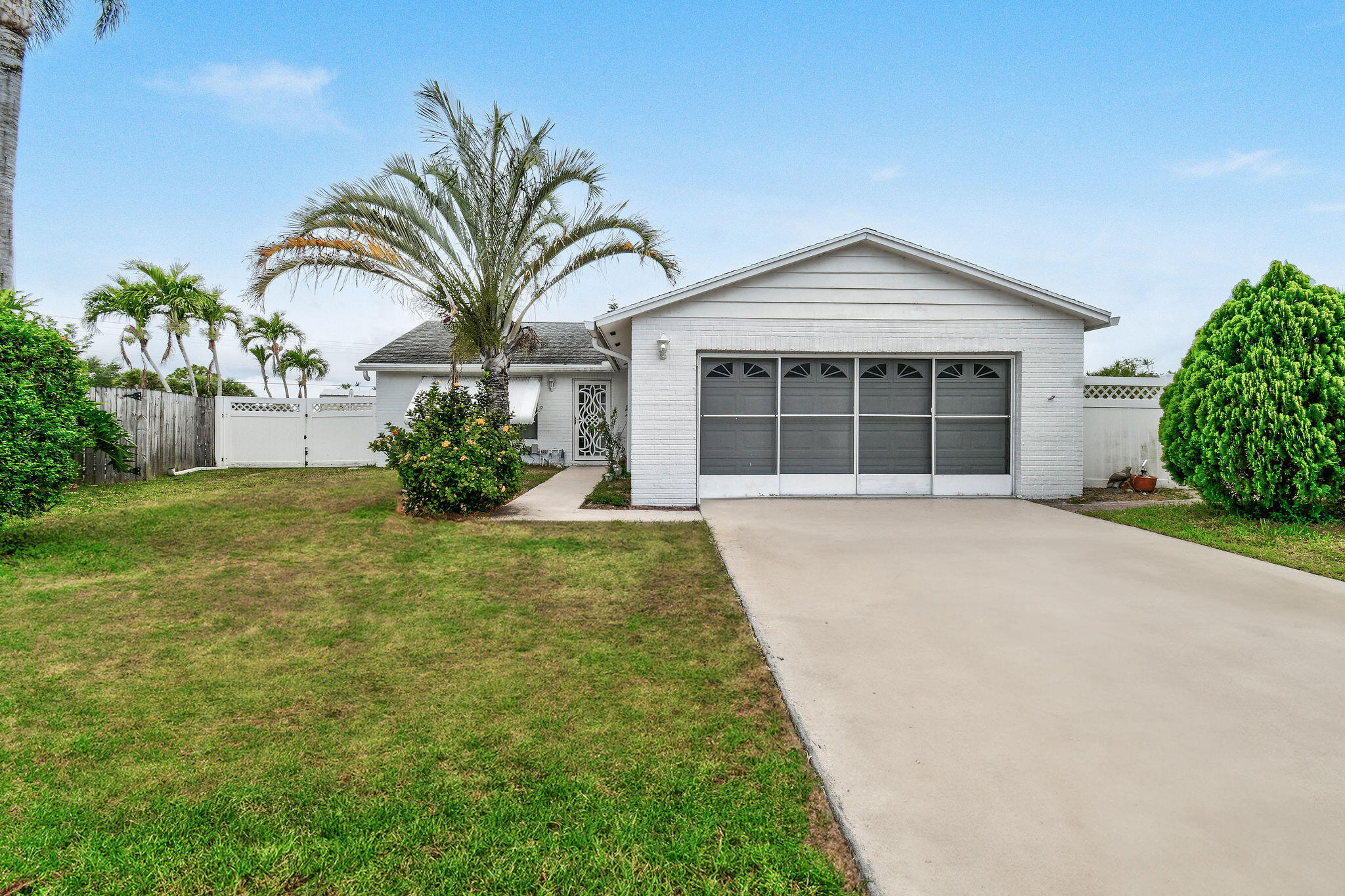 160 Banyan Circle Jupiter, FL 33458 - Photo 7 of 62 a view of a house with a yard and potted plants