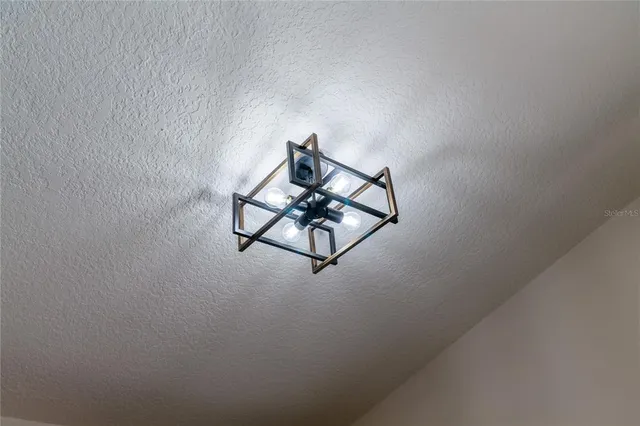 a bedroom with bed and a chair