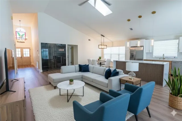a living room with furniture wooden floor and a flat screen tv