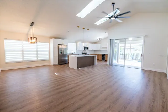 a view of a kitchen with a sink cabinets and wooden floor