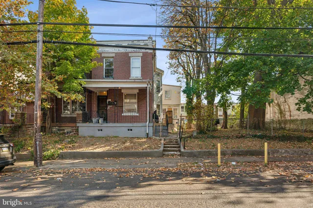 a view of a house with a tree in front
