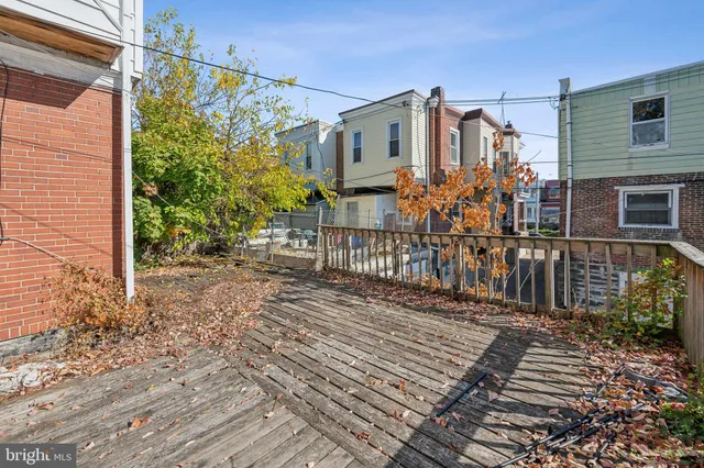 a view of a house with wooden fence