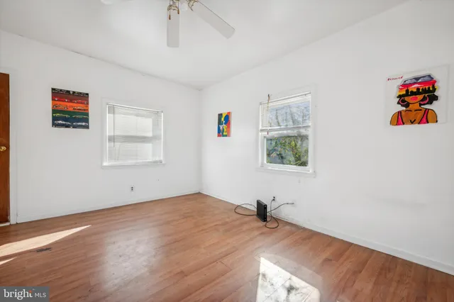 a view of a livingroom with wooden floor and a window