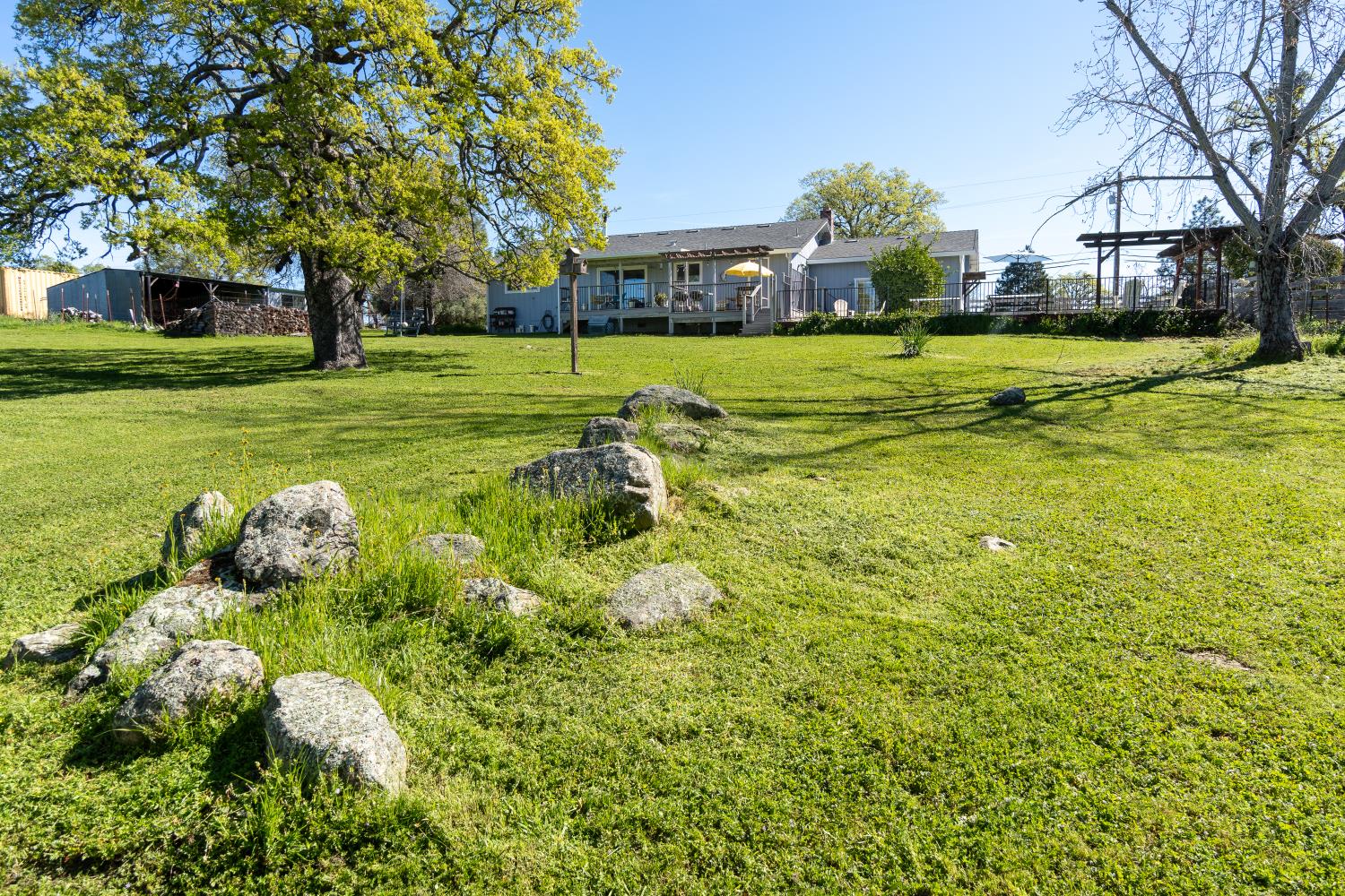 6980 Crystal Boulevard El Dorado, CA 95623 - Photo 11 of 49 a backyard of a house with lots of green space and fountain
