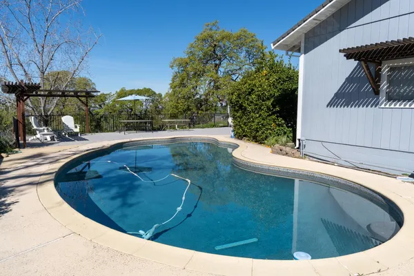 a view of a swimming pool with a patio