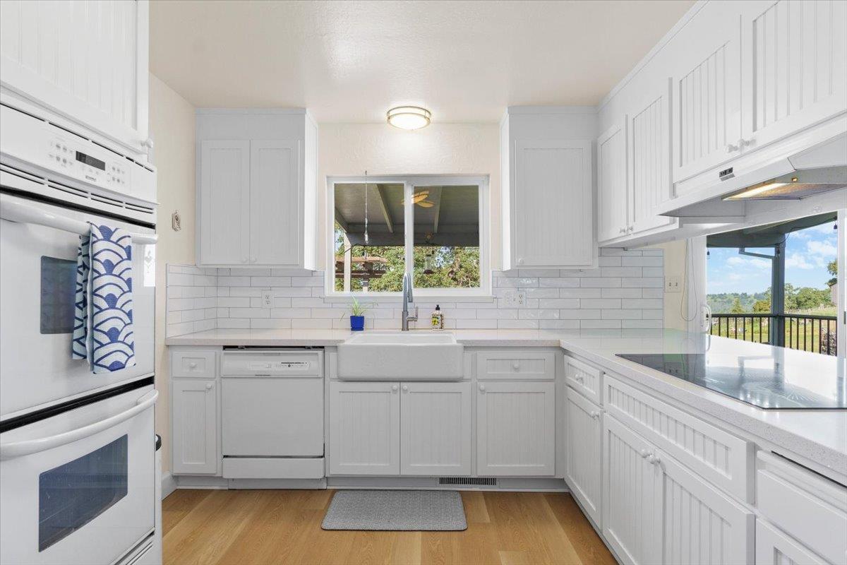6980 Crystal Boulevard El Dorado, CA 95623 - Photo 39 of 49 a kitchen with a sink stove and cabinets
