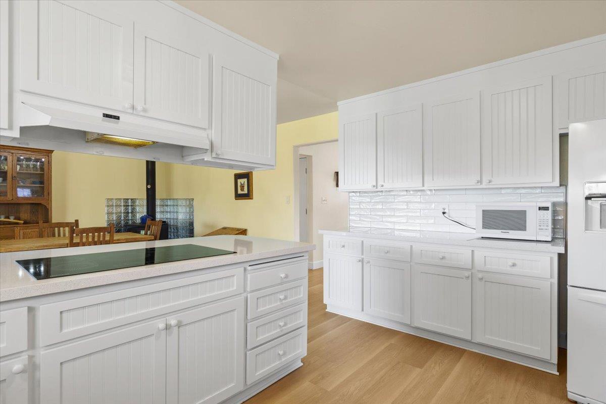 6980 Crystal Boulevard El Dorado, CA 95623 - Photo 40 of 49 a kitchen with white cabinets and white appliances