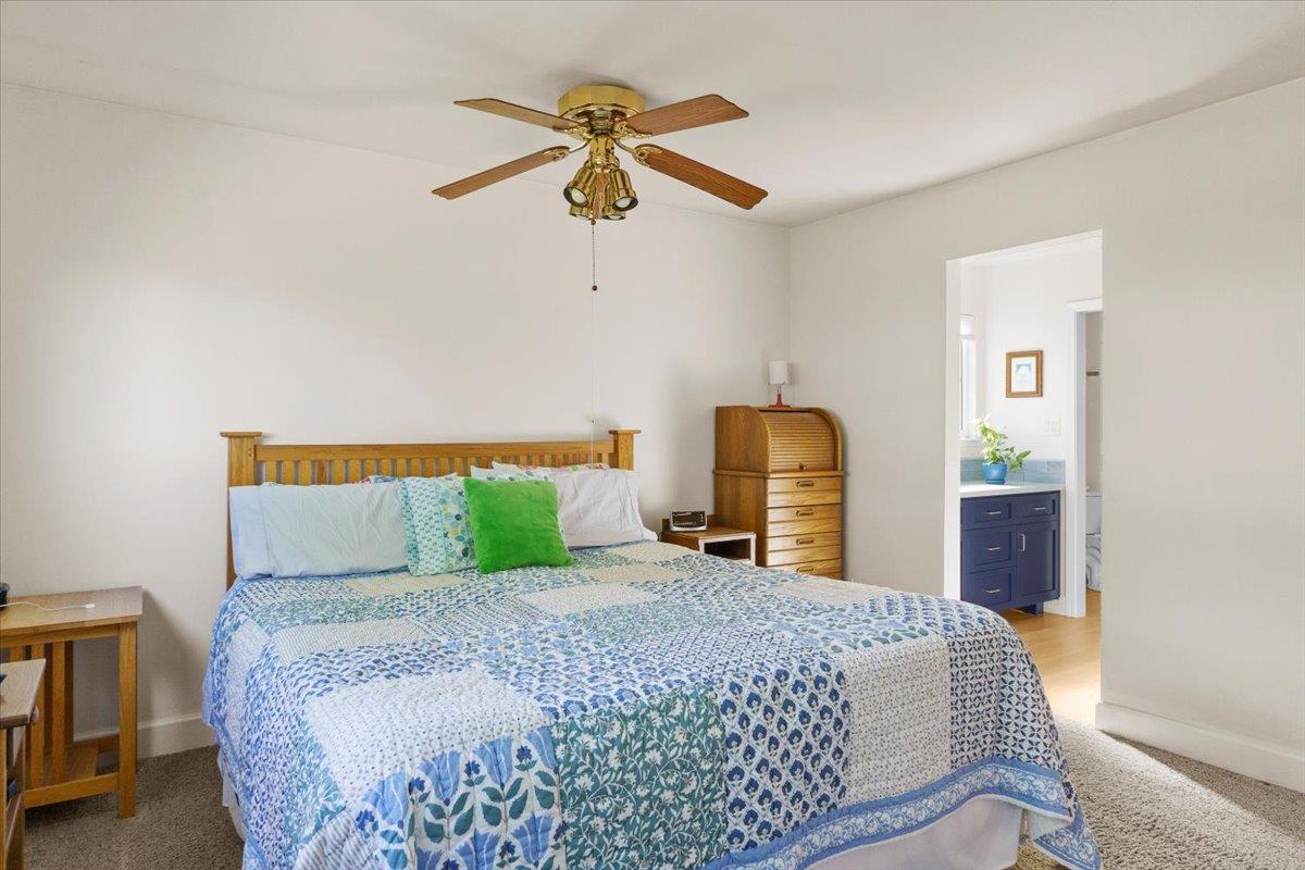 6980 Crystal Boulevard El Dorado, CA 95623 - Photo 46 of 49 a bedroom with a bed and a chandelier