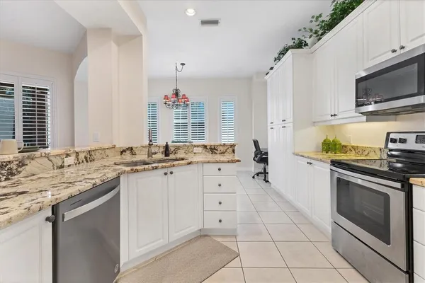 a kitchen with a stove a sink and a microwave