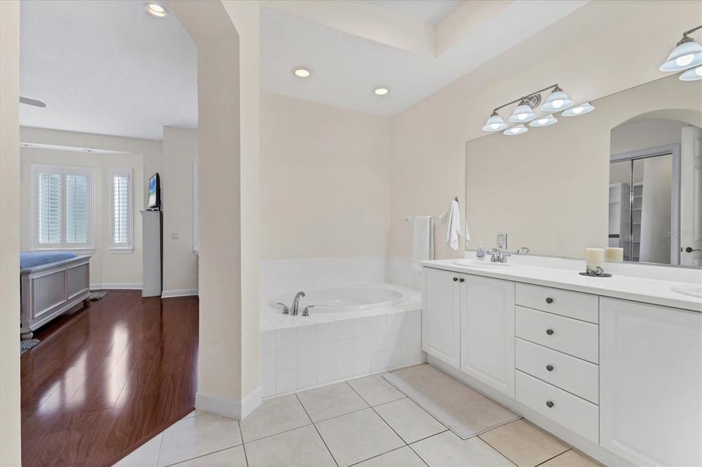 5425 46th Court West Bradenton, FL 34210 - Photo 15 of 39 a spacious bathroom with a double vanity sink a mirror and a bathtub