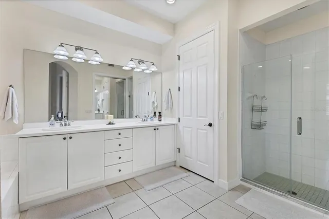 a spacious bathroom with a double vanity sink mirror and shower