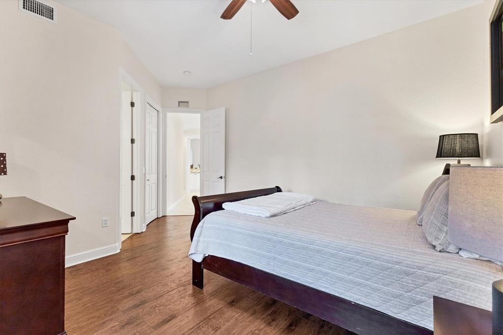 5425 46th Court West Bradenton, FL 34210 - Photo 18 of 39 a bedroom with a bed and wooden floor