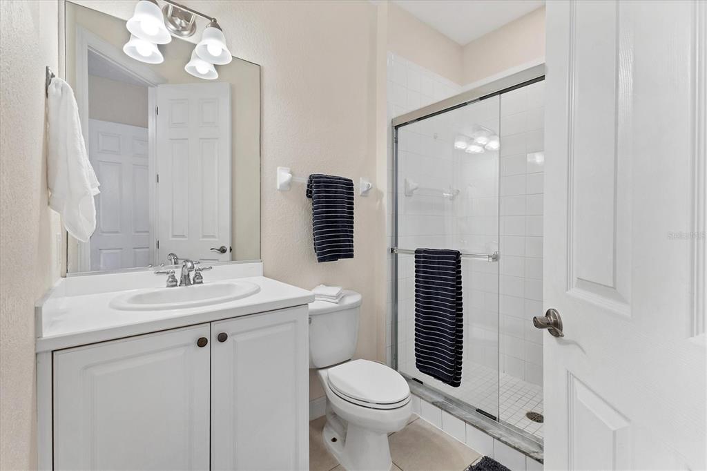 5425 46th Court West Bradenton, FL 34210 - Photo 19 of 39 a bathroom with a sink a toilet a mirror and shower curtain