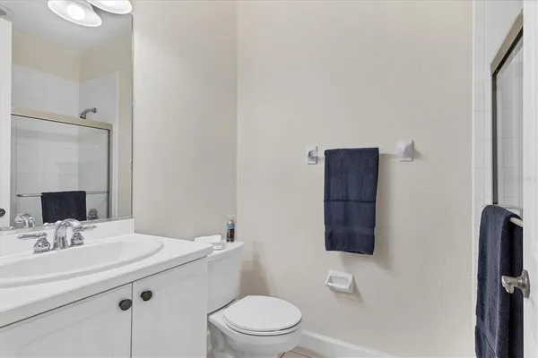 a bathroom with a sink toilet and mirror