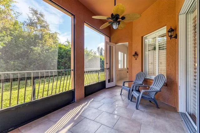 a view of a balcony with furniture and a yard