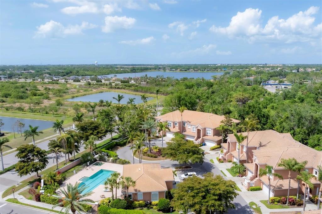 5425 46th Court West Bradenton, FL 34210 - Photo 29 of 39 an aerial view of a city with lots of residential buildings ocean and mountain view in back