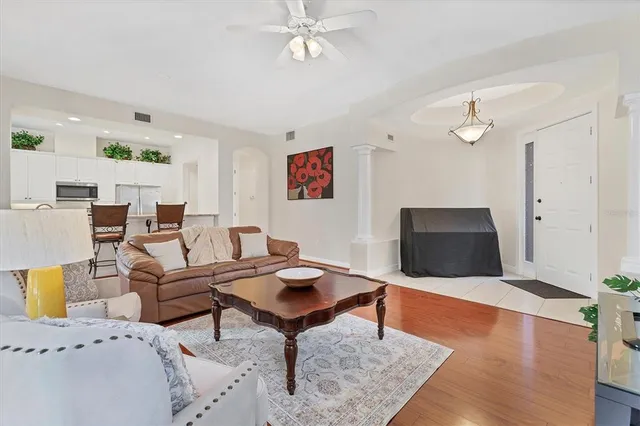 a living room with furniture and a wooden floor