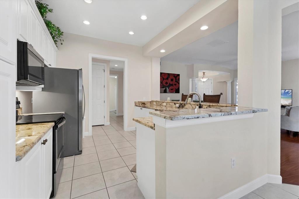 5425 46th Court West Bradenton, FL 34210 - Photo 10 of 39 a kitchen with stainless steel appliances granite countertop a refrigerator and a stove top oven