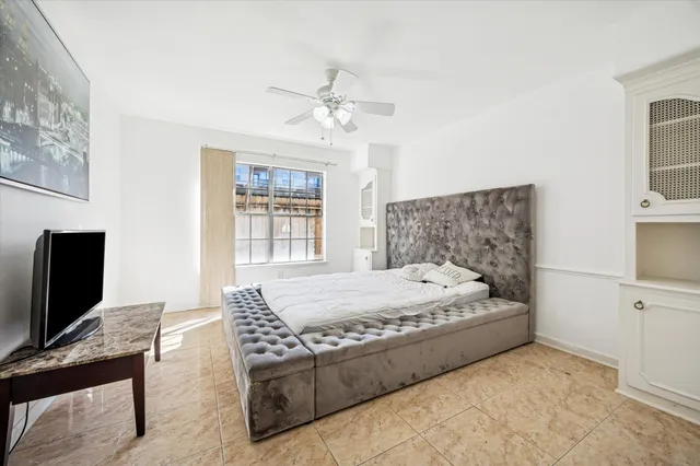 a view of a small space with wooden floor and a window