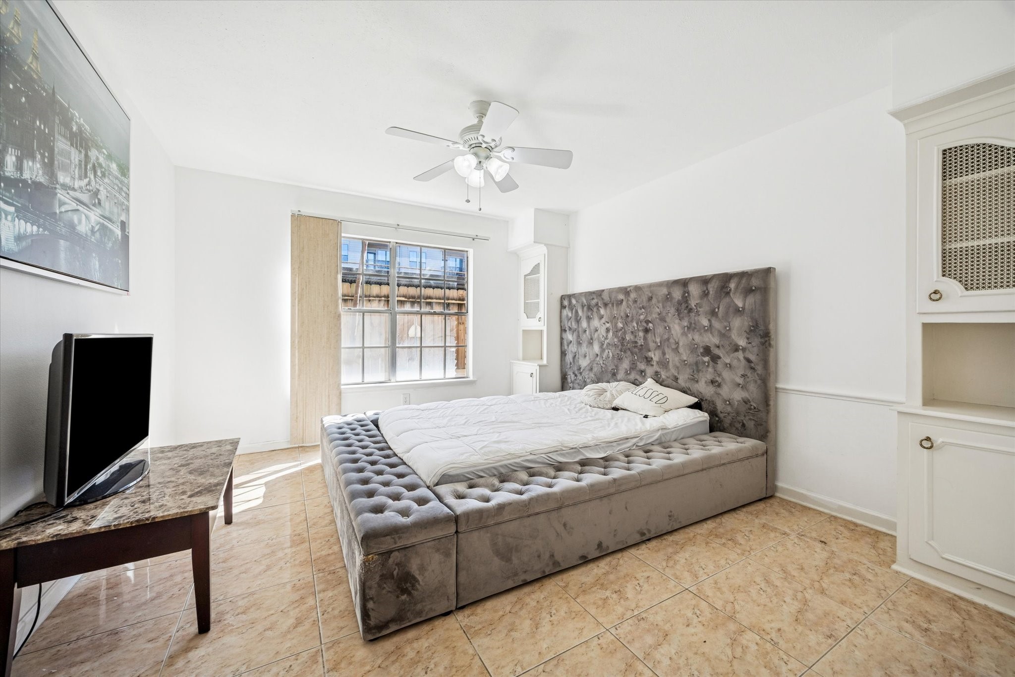 7600 Burgoyne Road, Unit 143 Houston, TX 77063 - Photo 7 of 17 a bedroom with a bed and a flat screen tv