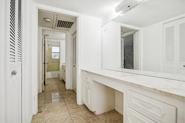 a bathroom with a granite countertop sink and a bathtub
