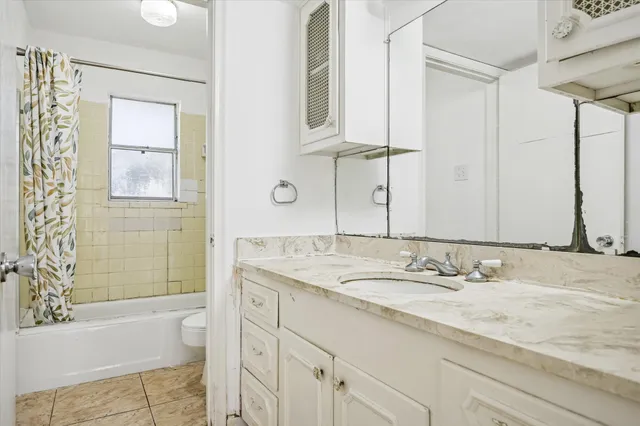 a bathroom with a glass door and a shower