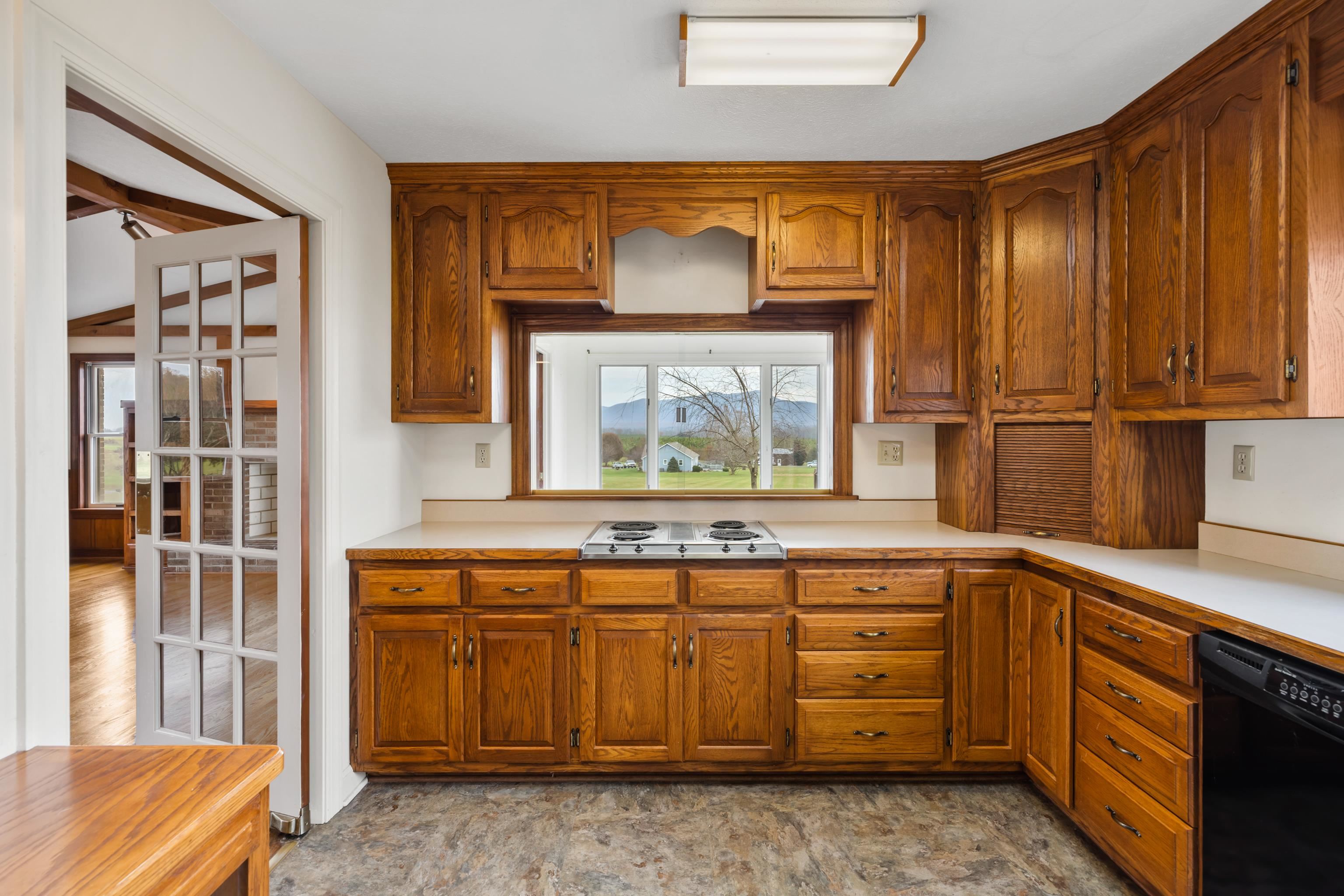 53 Strickley Road Grottoes, VA 24441 - Photo 15 of 58 a kitchen with stainless steel appliances wooden cabinets and a stove top oven